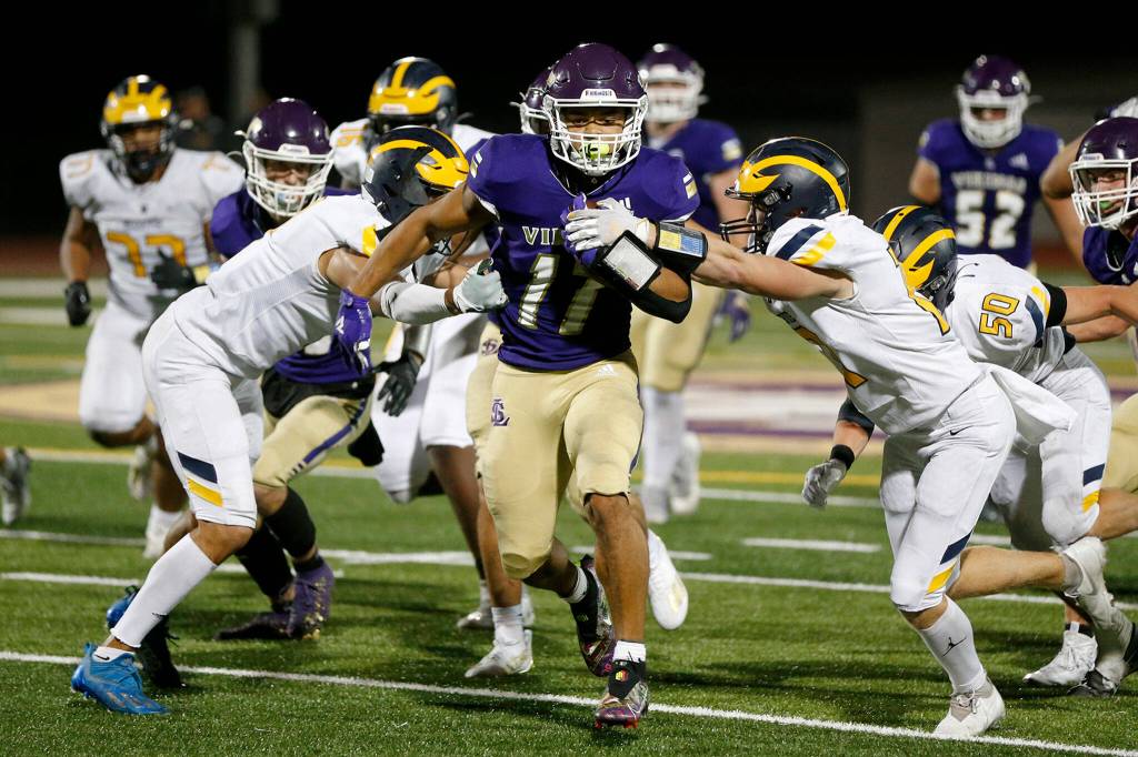 Lake Stevens’ Jayden Limar muscles through the defense against Bellevue on Friday, Sep. 9, 2022, at Lake Stevens High School in Lake Stevens, Washington. (Ryan Berry / The Herald)