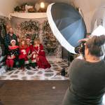 Stacy Yonkaitis of Stacy Lee Photography takes Christmas photos of the Hancock family  Josh, Rhonda and 10-year-old Tuesday  with Santa Brett Nichols and Tami Nichols as Mrs. Claus on Dec. 4, in Monroe. (Ryan Berry / The Herald)