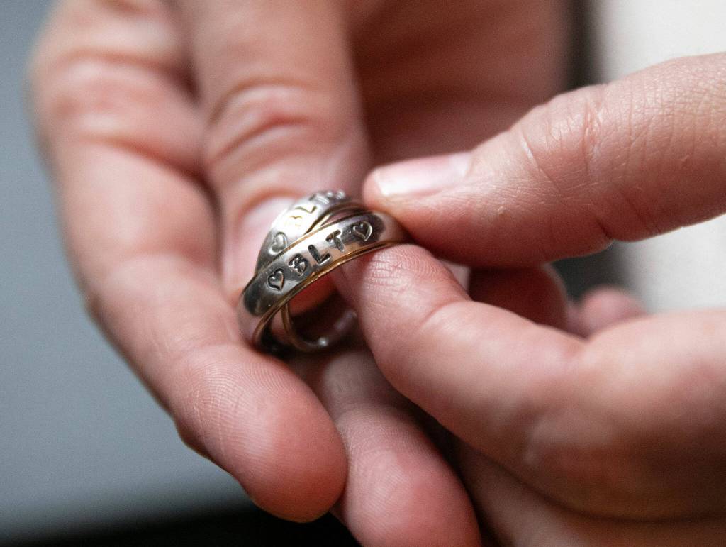Tami Nichols holds her and her husbands wedding rings two weeks after their Nov. 20 marriage at Snoqualmie Pass on Dec. 4, in Monroe. The rings read BLT, which stands for Brett Loves Tami. To stay on theme, the two had BLT sandwiches the morning of their wedding. (Ryan Berry / The Herald)