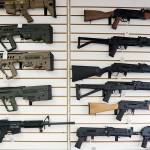 FILE - In this photo taken Oct. 2, 2018, semi-automatic rifles fill a wall at a gun shop in Lynnwood, Wash. Gov. Jay Inslee is joining state Attorney General Bob Ferguson to propose limits to magazine capacity and a ban on the sale of assault weapons. (AP Photo/Elaine Thompson, File)