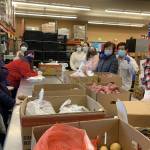 Village Experience Learning Center participants volunteering at Marysville Community Food Bank. - Photo courtesy of Village Community Services.