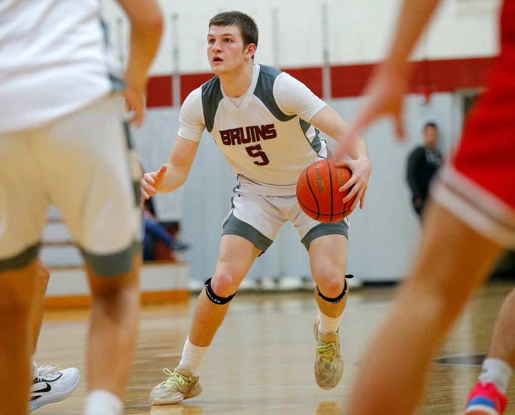 Cascades Devin Gilbert takes the ball at the top of the key against Stanwood on Thursday, Dec. 8, 2022, at Cascade High School in Everett, Washington. (Ryan Berry / The Herald)