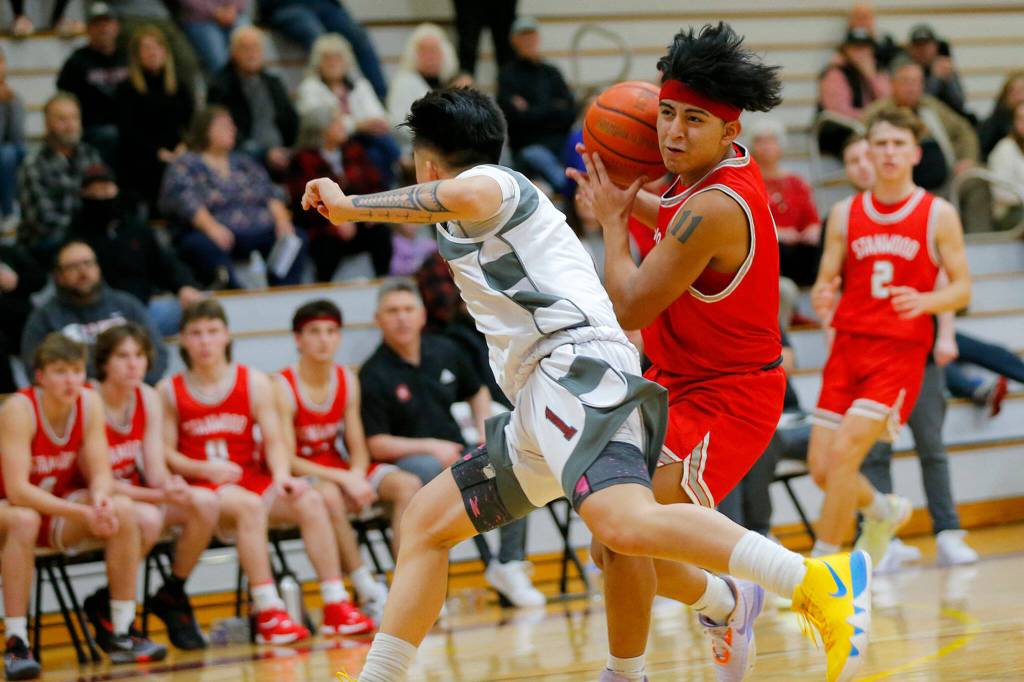 Stanwoods Alex Velazquez sidesteps a defender while on the fast break against Cascade on Thursday, Dec. 8, 2022, at Cascade High School in Everett, Washington. (Ryan Berry / The Herald)