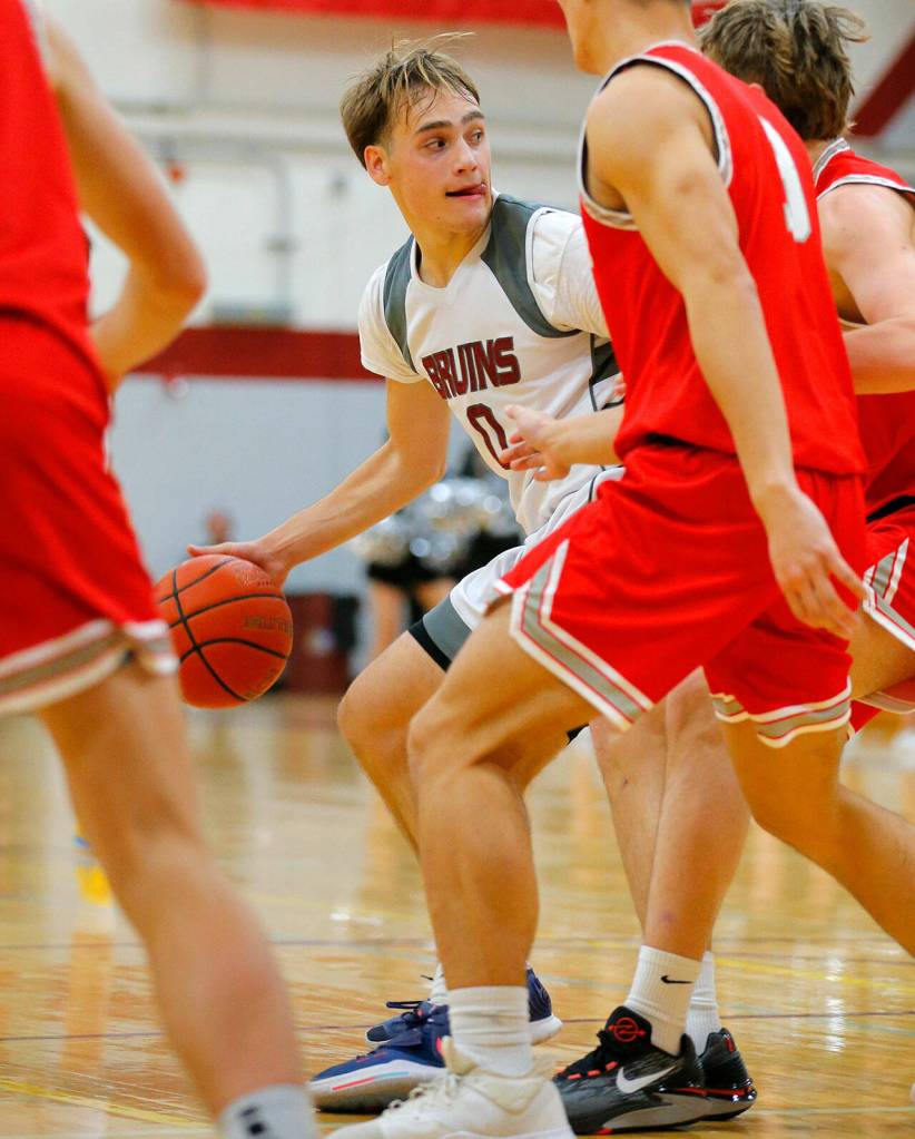 Cascades Aidan Kopra backs down a defender against Stanwood on Thursday, Dec. 8, 2022, at Cascade High School in Everett, Washington. (Ryan Berry / The Herald)