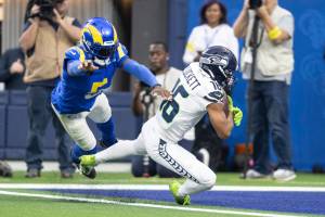 Seattle Seahawks wide receiver Tyler Lockett (16) scores a touchdown past Los Angeles Rams cornerback Jalen Ramsey (5) during an NFL football game, Sunday, Dec. 4, 2022, in Inglewood, Calif. (AP Photo/Kyusung Gong)