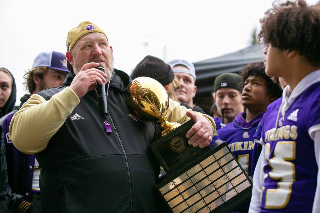 Coach Eric Dinwiddie takes a moment to talk about the dedication of the team during Lake Stevens High Schools 4A football championship parade Saturday, Dec. 10, 2022, in Lake Stevens, Washington. (Ryan Berry / The Herald)