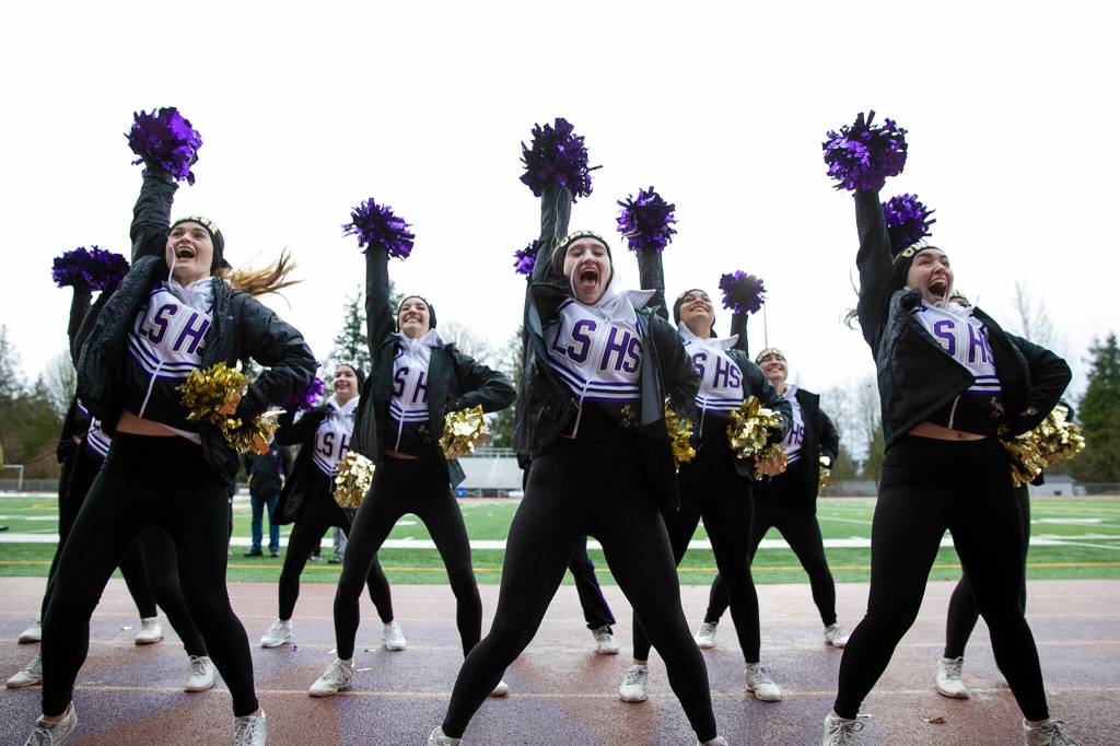 The Lake Stevens High School cheer squad leads a cheer during the schools 4A football championship parade Saturday, Dec. 10, 2022, in Lake Stevens, Washington. (Ryan Berry / The Herald)