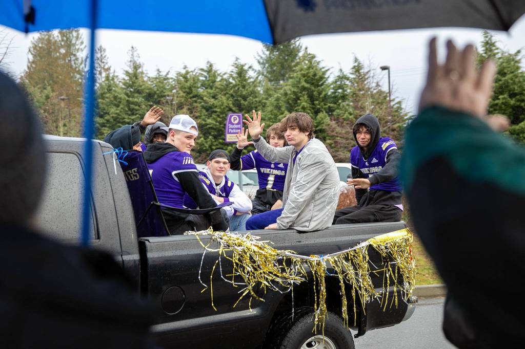 Members of the Lake Stevens football team roll up to the school during their championship parade Saturday, Dec. 10, 2022, in Lake Stevens, Washington. (Ryan Berry / The Herald)