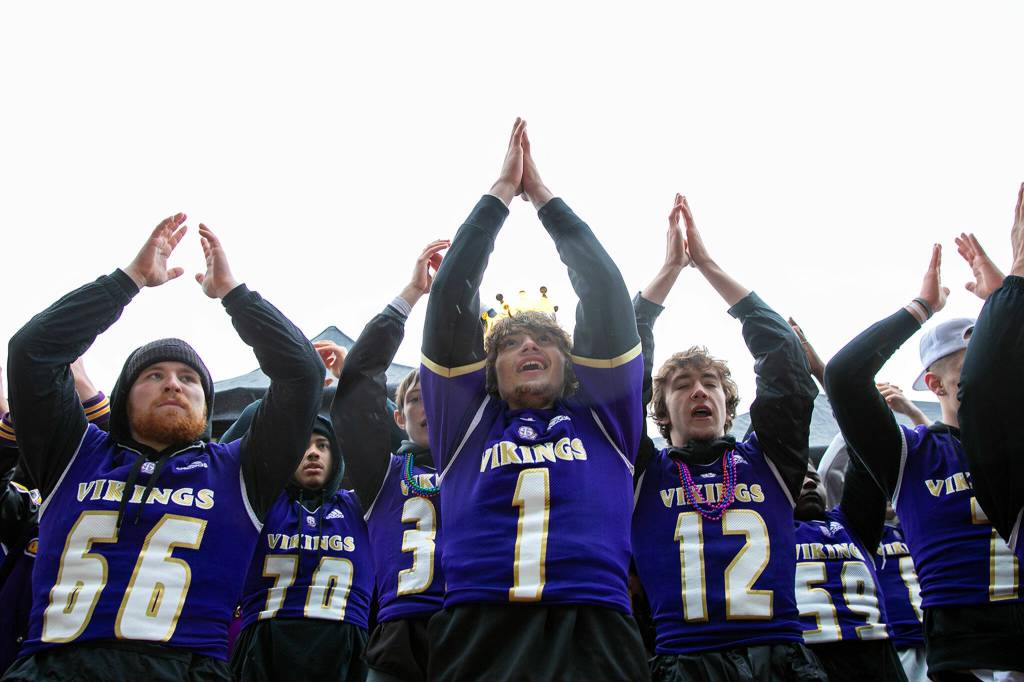 Lake Stevens football players help lead the crowd in a cheer during their 4A football championship parade Saturday, Dec. 10, 2022, in Lake Stevens, Washington. (Ryan Berry / The Herald)