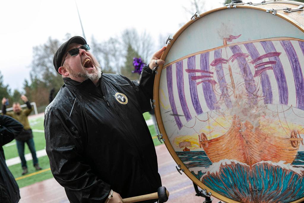 Band director Neil Proff leads a cheer with the Viking Spirit Drum during Lake Stevens High Schools 4A football championship parade Saturday, Dec. 10, 2022, in Lake Stevens, Washington. (Ryan Berry / The Herald)