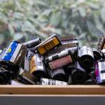 Spent film canisters from over the years line the windowsills at Kens Camera on Thursday, Dec. 15, 2022, in Everett, Washington. (Ryan Berry / The Herald)