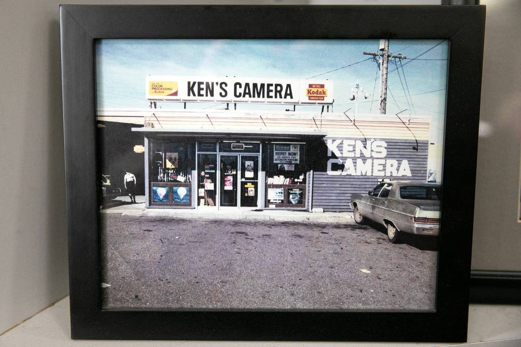 An old photo of the original Kens Camera in Lynnwood is tucked away behind the counter at the Evergreen location on Thursday, Dec. 15, 2022, in Everett, Washington. (Ryan Berry / The Herald)
