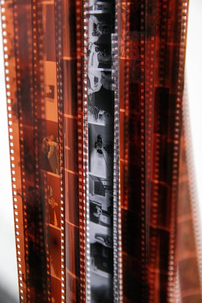Rolls of customers developed negatives hang in the lab before being scanned and digitized at Kens Camera on Thursday, Dec. 15, 2022, in Everett, Washington. (Ryan Berry / The Herald)