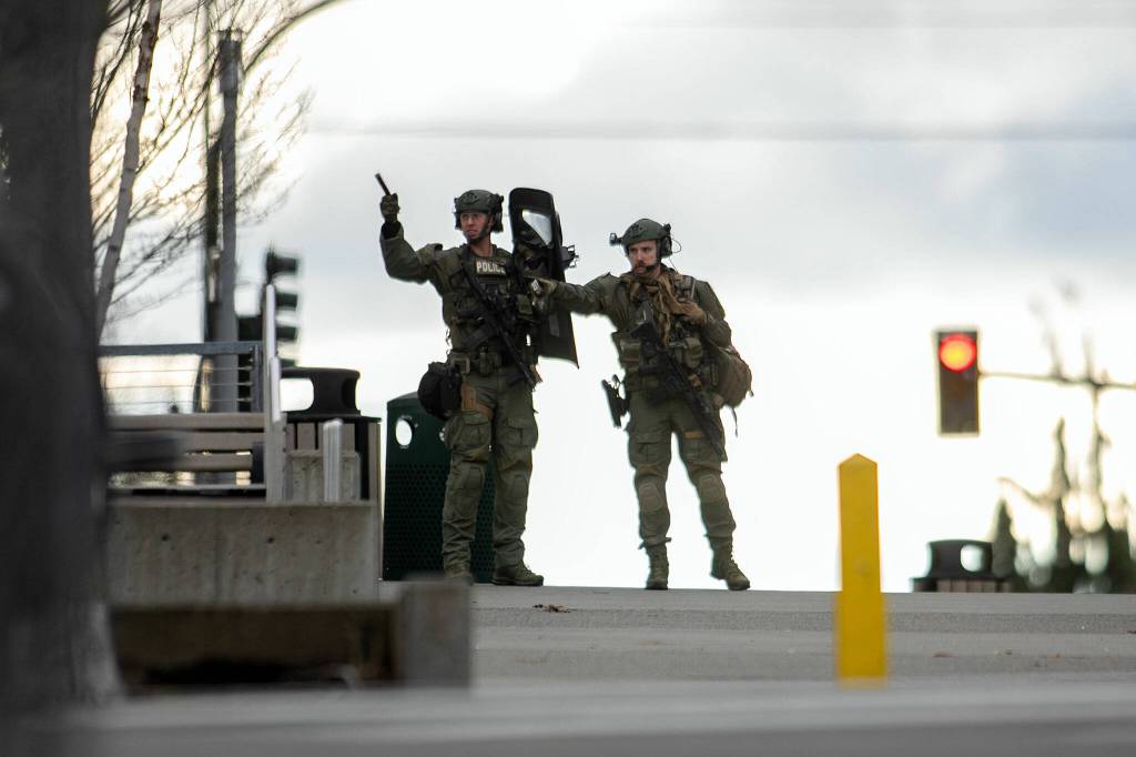 Law enforcement in heavy gear operate outside the Snohomish County Superior Courthouse during a lockdown Monday, in downtown Everett. (Ryan Berry / The Herald)