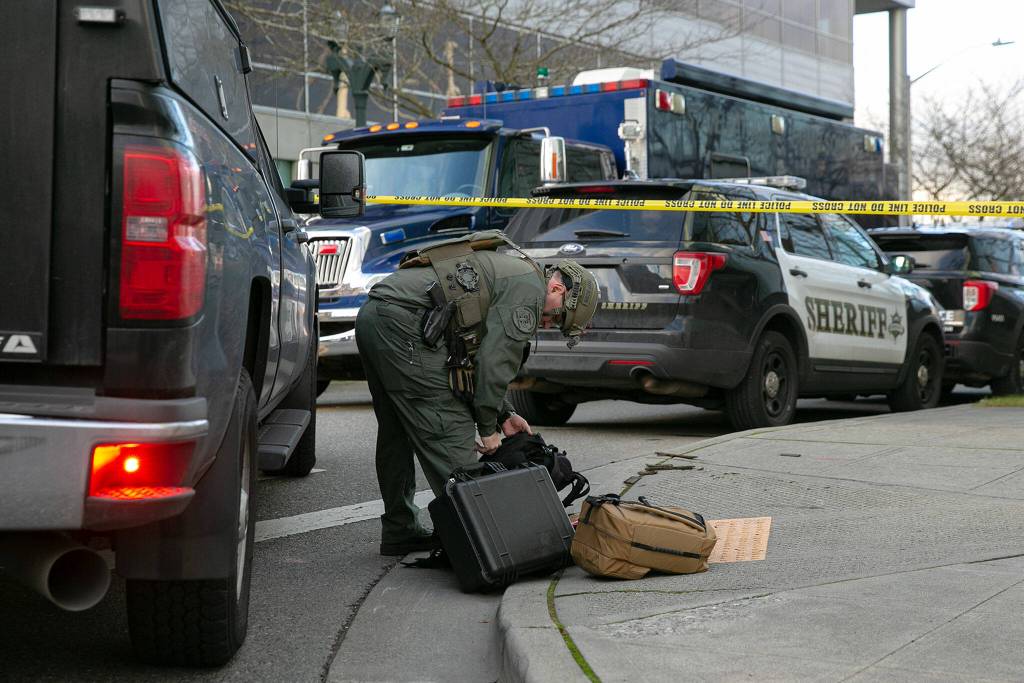 A member of the bomb squad prepares some gear during a lockdown at the Snohomish County Courthouse on Monday, in downtown Everett. (Ryan Berry / The Herald)