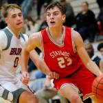 Stanwood’s Cole Williams dribbles past a defender on his way to the net against Cascade on Thursday, Dec. 8, 2022, at Cascade High School in Everett, Washington. (Ryan Berry / The Herald)