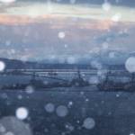 Snow begins to fall over Everett as the sun sets on Sunday, Dec. 18, 2022 in Everett, Washington. (Olivia Vanni / The Herald)