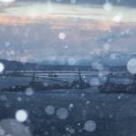 Snow begins to fall over Everett as the sun sets on Sunday, Dec. 18, 2022 in Everett, Washington. (Olivia Vanni / The Herald)