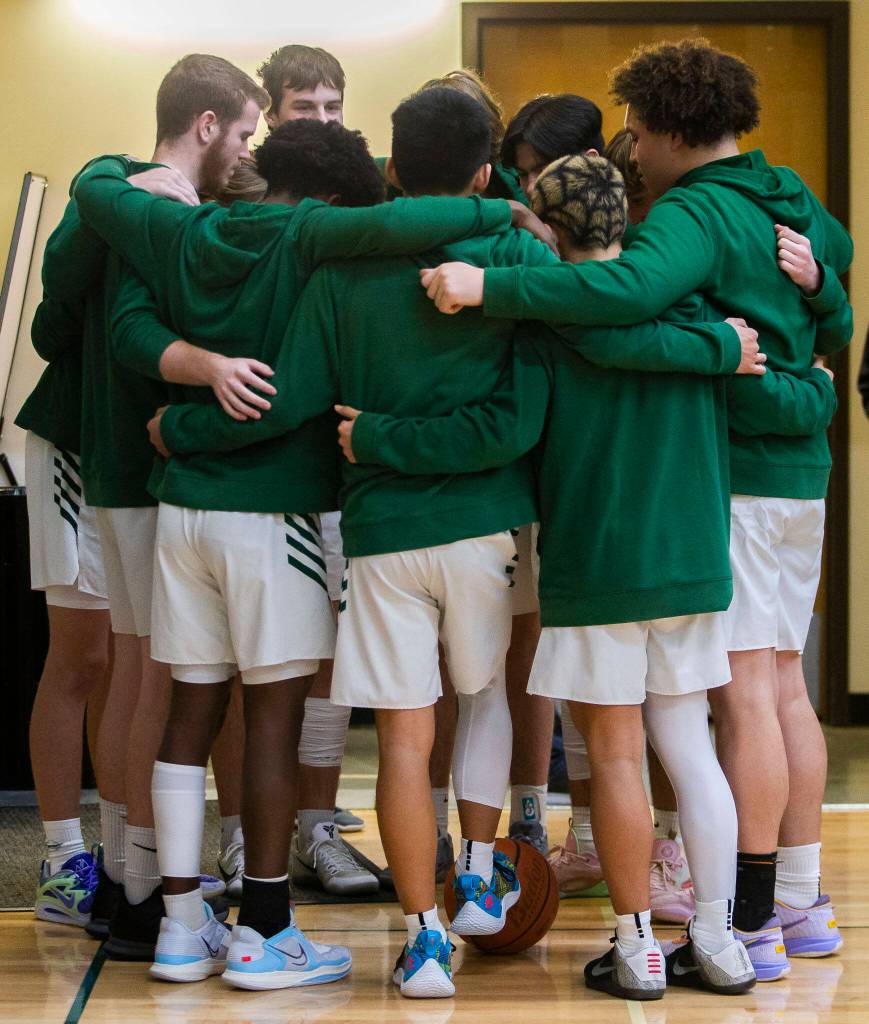 The Shorecrest players huddle before the game on Friday, Dec. 16, 2022 in Marysville, Washington. (Olivia Vanni / The Herald)