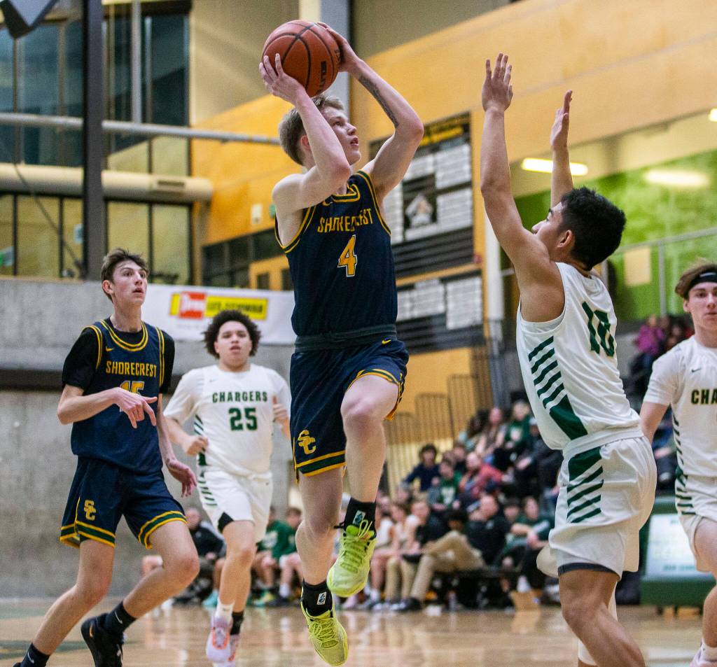 Shorecrests Anthony Najera leaps to make a pass during the game against Marysville Getchell on Friday, Dec. 16, 2022 in Marysville, Washington. (Olivia Vanni / The Herald)