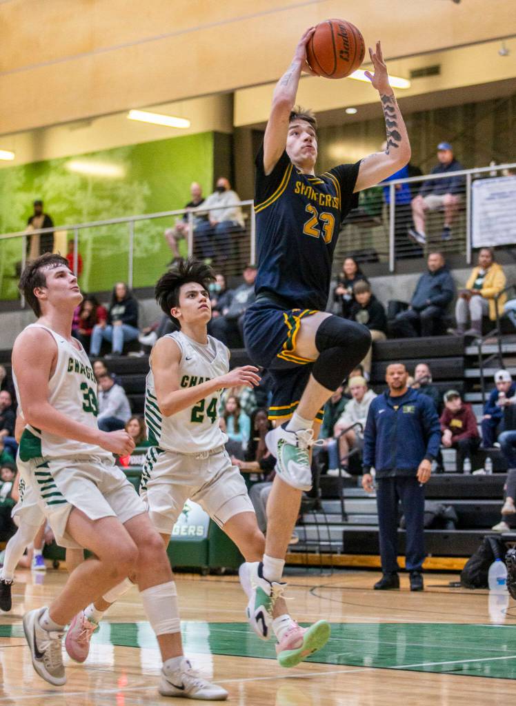 Shorecrests Parker Baumann leaps in the air to make a layup during the game against Marysville Getchell on Friday, Dec. 16, 2022 in Marysville, Washington. (Olivia Vanni / The Herald)