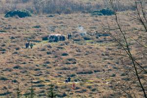 Emergency responders surround the wreckage of an airplane that crashed into a field along U.S. 2 just east of Snohomish on Friday, Nov. 18, 2022, in Snohomish, Washington. (Ryan Berry / The Herald)