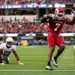 Fresno State running back Jordan Mims (7) scores a touchdown during the first half of the LA Bowl in Inglewood, Calif., Saturday, Dec. 17, 2022. Washington State defensive back Jordan Lee (13) is at left. (AP Photo/Ashley Landis)