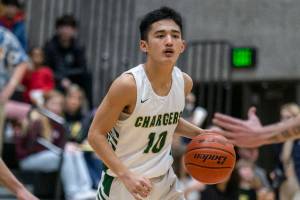 Marysville-Getchell’s Arion Palacol looks for an open teammate to pass to during the game against Shorecrest on Friday, Dec. 16, 2022 in Maryville, Washington. (Olivia Vanni / The Herald)