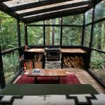 At 375 square feet, Cabin 2 is the smallest unit at Cabin Creek Cabins. Shown here is a sunroom with a sofa and a fireplace. (Ryan Berry / The Herald)
