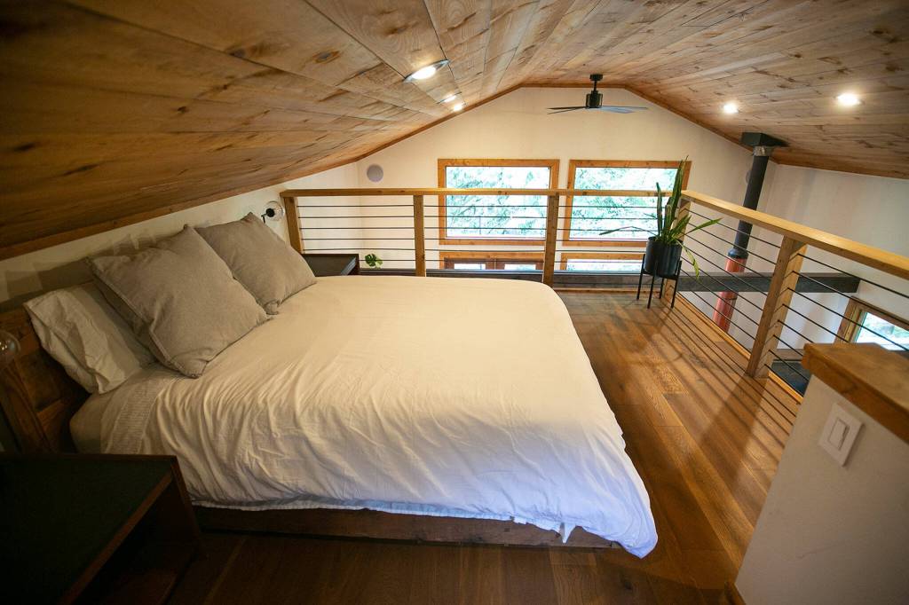A lofted space holds a bed in one of the three cabins at Canyon Creek Cabins on Sep. 23 in Granite Falls. (Ryan Berry / The Herald)