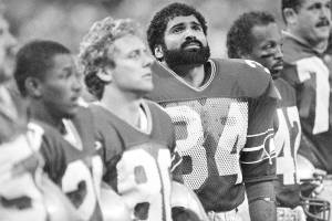 Running back Franco Harris stands with his new teammates before the game against San Diego, Sept. 11, 1984, in Seattle. Harris joined the Seattle Seahawks after Curt Warner suffered a knee injury in he Seahawks season opener. Seattle won 31-17. Other players are unidentified. (AP Photo/Barry Sweet)