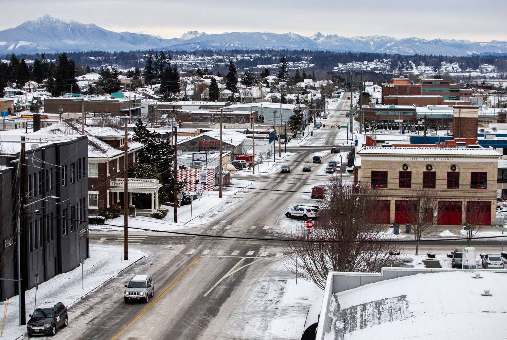 Drivers make their way through downtown Everett on Thursday. (Olivia Vanni / The Herald)