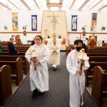 Father Tuan Nguyen walks down the aisle at the end of morning mass at Immaculate Conception Church on Wednesday, May 4, 2022 in Everett, Washington. (Olivia Vanni / The Herald)