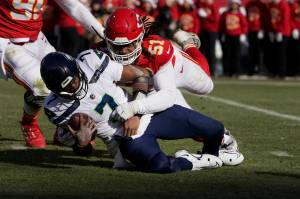 Seattle Seahawks quarterback Geno Smith (7) is sacked by Kansas City Chiefs defensive end Mike Danna (51) during the first half of Saturdays game in Kansas City, Mo. (AP Photo/Ed Zurga)