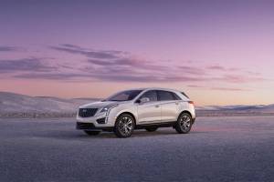 2023 Cadillac XT5 Premium Luxury shown in Crystal White Tricoat with 20” alloy wheels, front 3/4 angle. (Cadillac)