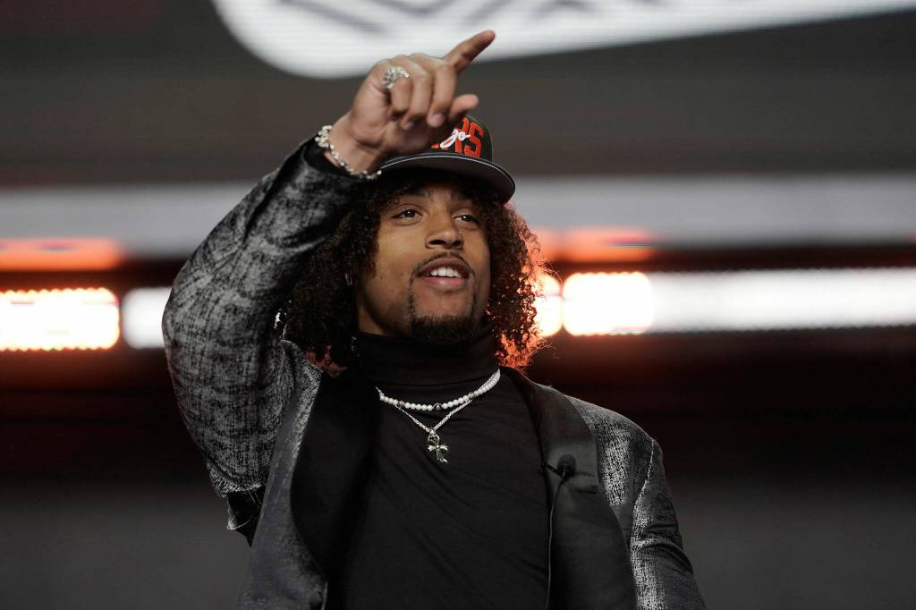 Washington cornerback Kyler Gordon, an Archbishop Murphy High School alum, points after being selected by the Chicago Bears during the second round of the NFL draft April 29, 2022, in Las Vegas. (AP Photo/Jae C. Hong)