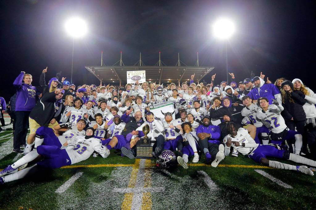 The 2022 Lake Stevens Vikings celebrate their championship victory over Kennedy Catholic in the WIAA 4A State Football Championship game Saturday, Dec. 3, 2022, at Mount Tahoma Stadium in Tacoma, Washington. (Ryan Berry / The Herald)
