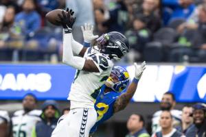 Seattle Seahawks cornerback Tariq Woolen (27) intercepts a pass intended Los Angeles Rams running back Kyren Williams (23) during an NFL football game, Sunday, Dec. 4, 2022, in Inglewood, Calif. (AP Photo/Kyusung Gong)