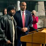 U.S. Attorney Nick Brown and the victim of a brutal attack in 2018 answer questions from reporters on Jan. 27, 2023 in Seattle, Washington. (Jake Goldstein-Street / The Herald)