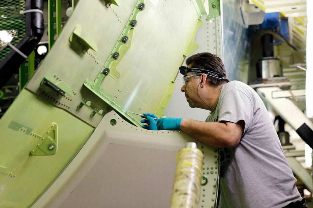 Boeing employee works on a Boeing 777 jet under construction on May 29, 2013, at the companys production plant in Everett, Wash. (AP Photo / Elaine Thompson)