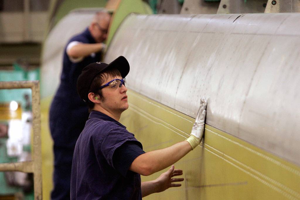 Jeffrey Barth works on the wing of a Boeing 767 being prepped for sealing on Aug. 6 2007, in Everett. (AP Photo / Elaine Thompson, file)