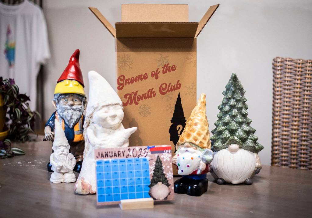 Each $30 box contains a gnome-inspired lawn ornament, along with a knick-knack like a mug, T-shirt, fridge magnet or bumper sticker, and a postcard-size calendar featuring that months gnome. (Olivia Vanni / The Herald)