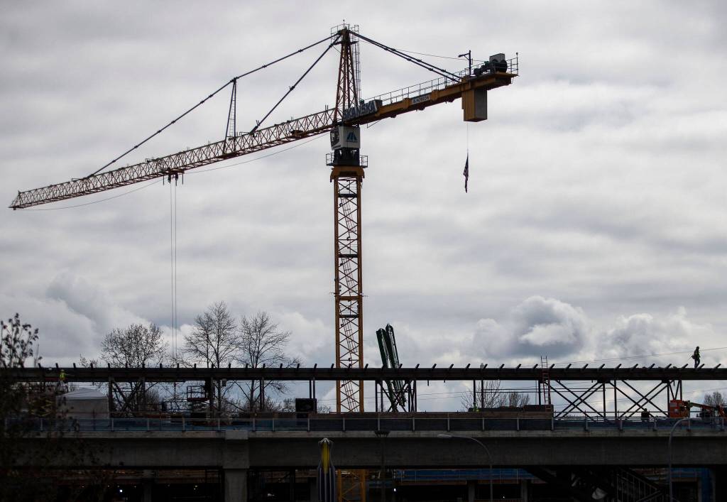 Crews work on the Lynnwood light rail station Tuesday in Lynnwood. (Olivia Vanni / The Herald)