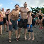 Three generations of Larson boys  grandpa Dan, father Chris, and 9-year-old Jack  take a moment for a photo before taking the plunge during the 2023 Edmonds Polar Bear Plunge on Sunday, Jan. 1, 2023, at Bracketts Landing in Edmonds, Washington. The polar plunge is a long-standing tradition for the family. (Ryan Berry / The Herald)