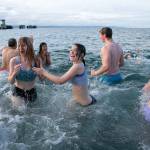 Brave plungers turn to retreat for dry land after getting a taste of the cold ocean waters during the 2023 Edmonds Polar Bear Plunge on Sunday, Jan. 1, 2023, at Bracketts Landing in Edmonds, Washington. (Ryan Berry / The Herald)