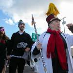 Edith Farrar blows a whistle and leads well over a hundred people to the waterfront during the 2023 Edmonds Polar Bear Plunge on Sunday, Jan. 1, 2023, at Bracketts Landing in Edmonds, Washington. (Ryan Berry / The Herald)