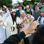 A group of plungers take a photo celebrating the new year before heading into the water during the 2023 Edmonds Polar Bear Plunge on Sunday, Jan. 1, 2023, at Bracketts Landing in Edmonds, Washington. (Ryan Berry / The Herald)