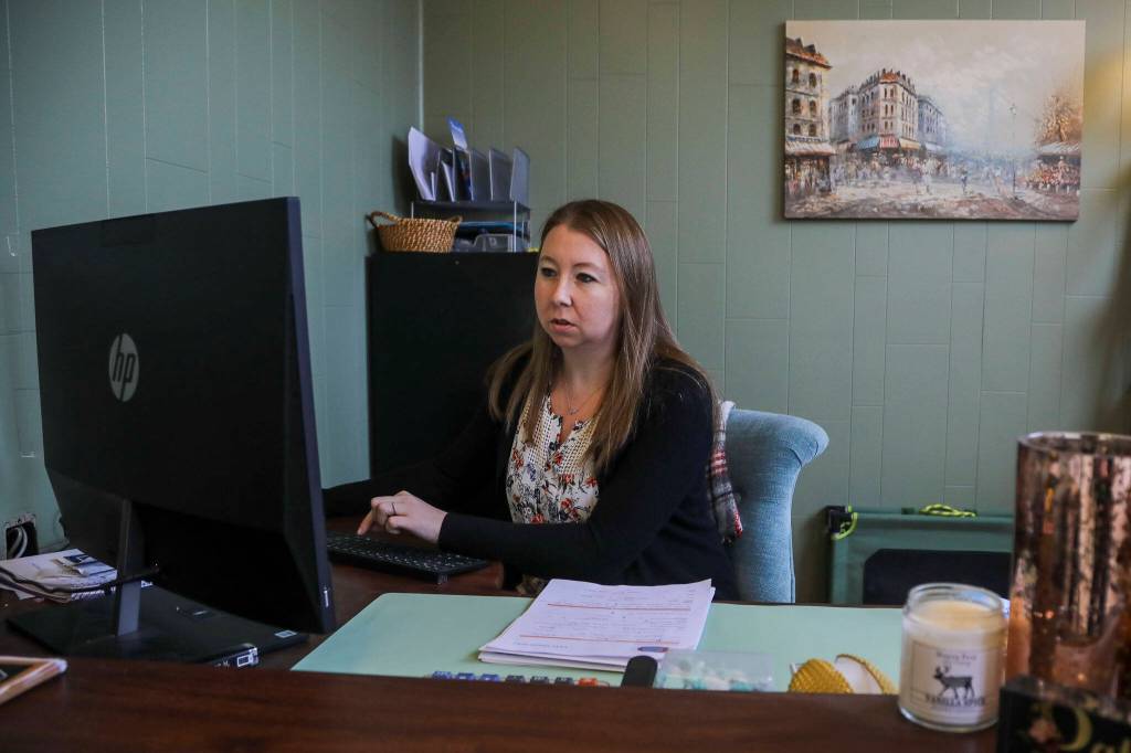 Patricia Cairus, 36, works at her desk at Fast Track Hvac in Stanwood on Monday. Nick Cairus and Patricia Cairus lost their housing in the recession and were homeless for a number of years. They started a successful HVAC company during the pandemic in a former newspaper printing building. (Annie Barker / The Herald)