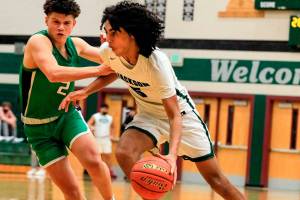 Jackson's Sylas Williams drives with Woodinville's Jamison Atwood defending at Jackson High School Wednesday evening in Mill Creek, Washington on January 5, 2022. The Timberwolves won 76-57. (Kevin Clark / The Herald)