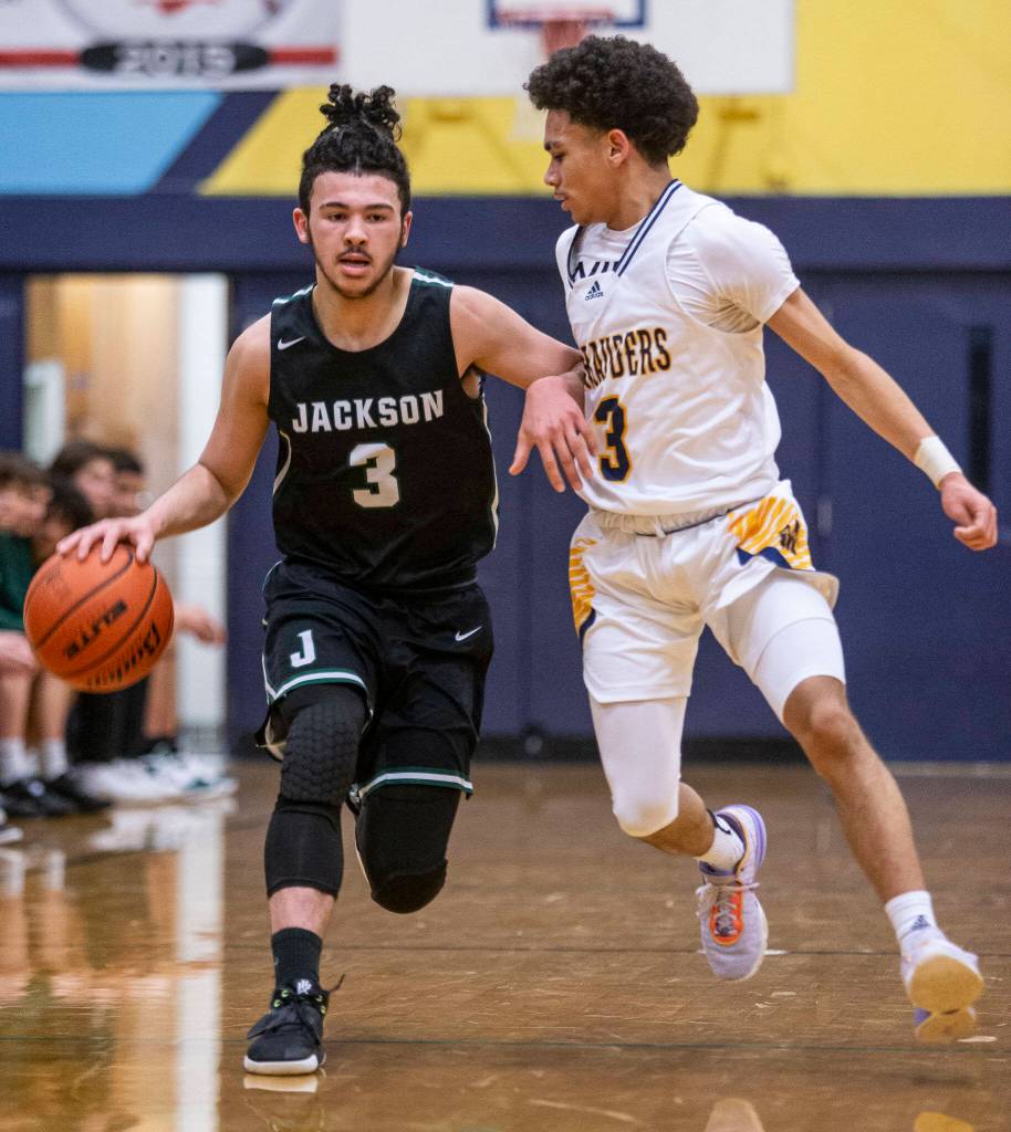 Mariners Macky James bumps into Jacksons Trey Hawkins as they run down the court during the game on Wednesday in Everett. (Olivia Vanni / The Herald)
